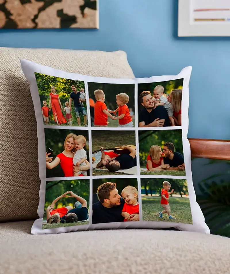 A white photo collage cushion featuring nine family moments displayed on a beige sofa in a cozy living room setting.